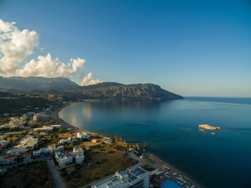 aerial-shot-houses-beach-by-beautiful-calm-ocean-captured-karpathos-greece.jpeg